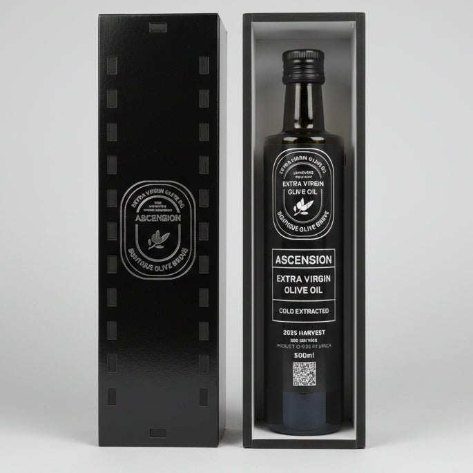 Bottle of Ascensión Extra Virgin Olive Oil in a wooden box on a wooden surface.