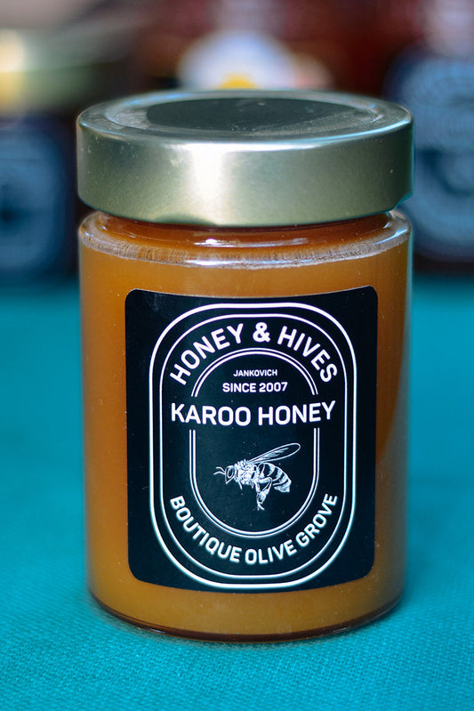 Jar of Karoo honey with 'Honey & Hives' label on a blue background
